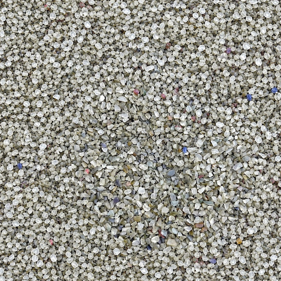 Gros plan sur les granulats de verre recyclé GlassRoxx teinte argent pailleté